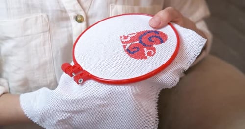 Woman Cross-Stitching a Colorful Design
