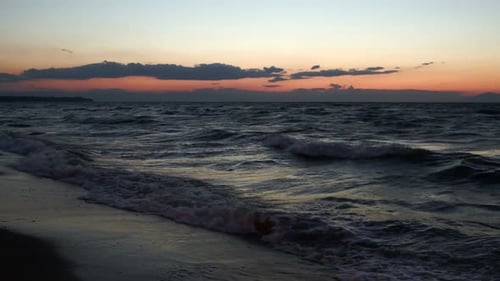 Scene of strong sea surf at sunset