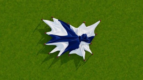 Finland Flag Unfurls on Green Grass Background