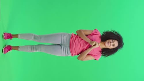 Woman Standing on Green Screen Smiling