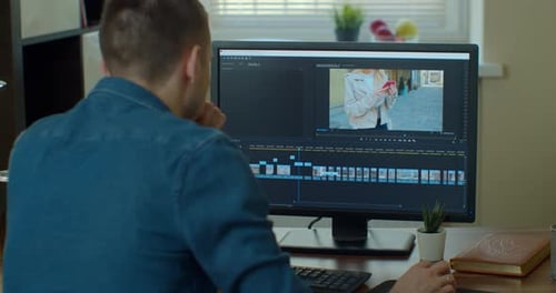 Post Production and Vlog Concept - Man Working in Video Editor Program on Laptop Computer at Home