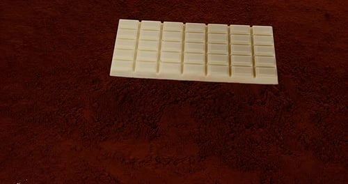 Bar of White Chocolate on Cocoa Powder