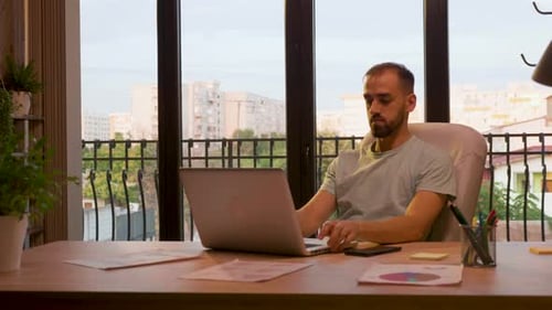 Successful CEO of Start Up Company Typing on the Laptop