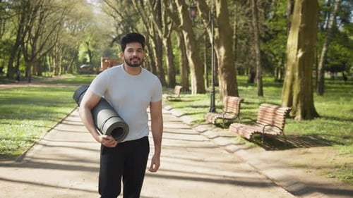 Portrait of Smiling Arab Man in Sport Clothes After Training at Park