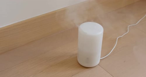 Humidifier Emitting Vapor on Wooden Floor