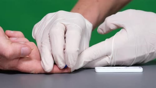 Close Up Finger Prick Blood Test on Green Screen