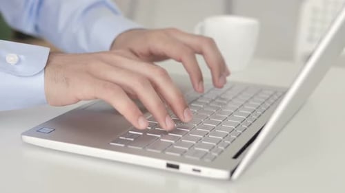 Close Up of Hands Typing On Laptop