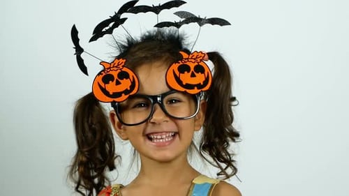 Smiling Girl Celebrates Halloween with Costume and Decorations