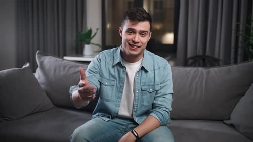 Young Man Talking to Camera on Sofa