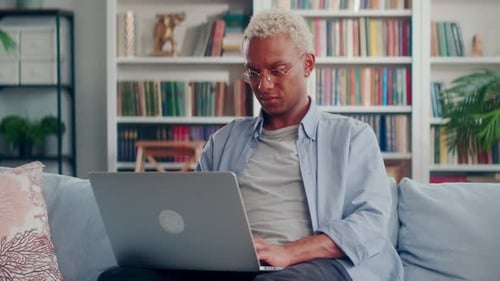 Young Adult Using Laptop Computer at Home