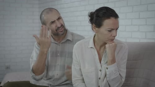 Woman Crying as Man Argues and Gestures Angrily