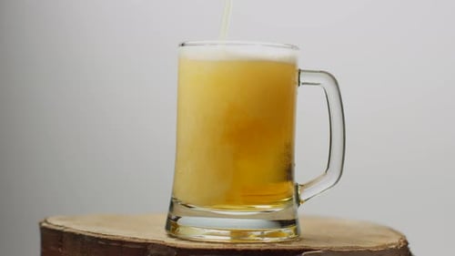 Golden Beer Being Poured in a Mug