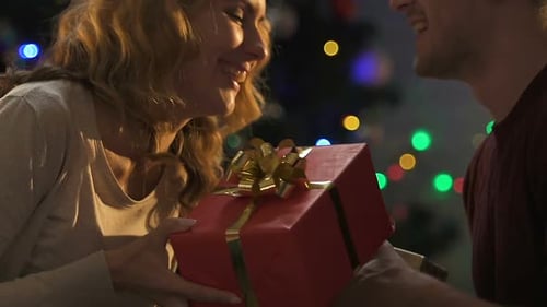 Young Couple Exchanging Gifts on Christmas Eve