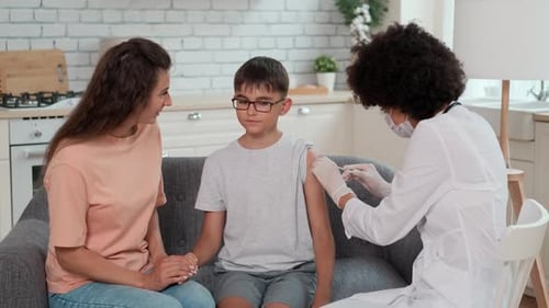 Child Gets a Vaccination in Home by Doctor