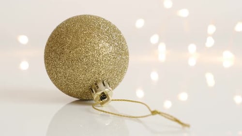 Golden bauble with sequins slow tilt 4K 2160p 30fps UltraHD footage - Gold color Christmas tree or