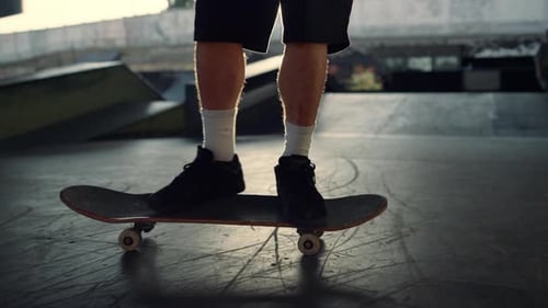 Young Skater Performing Jump Trick on Skateboard at Skate Park