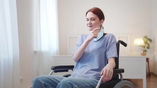 Woman in Wheelchair Removes Face Mask and Smiles