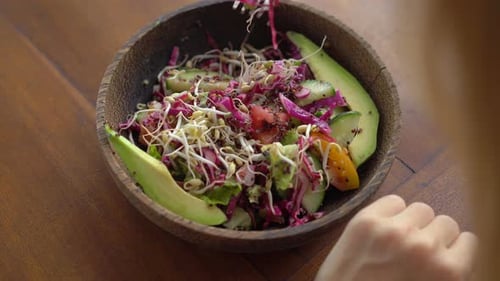 A Young Woman in a Tropical Cafe Eat Healthy Vegetarian Salad. Vegan Food Concept