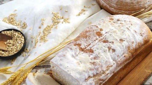 Rustic White Bread Sliced on Cutting Board