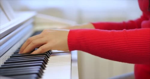 Woman Plays Piano Close Up in Home