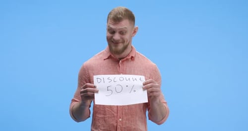 Man Holding a Discount 50 Percent Sign