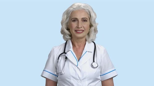 Mature Woman with Stethoscope Smiling in Medical Coat