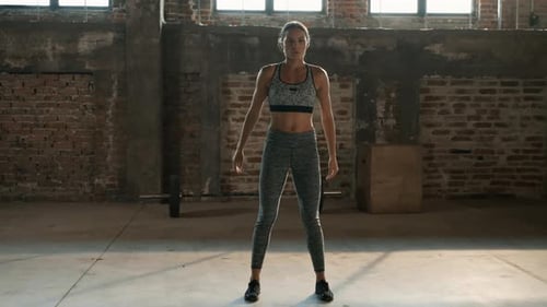 Fitness workout. Sport woman doing squat leg exercise at gym