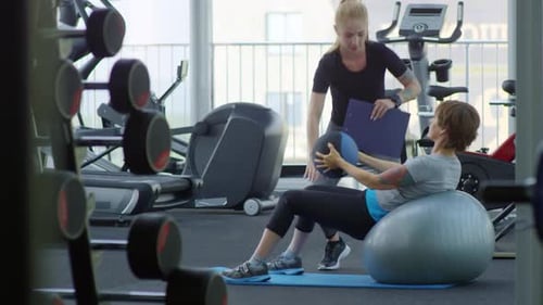 Woman Using Yoga and Medicine Ball