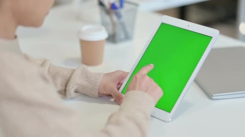 Woman Uses Tablet with Green Screen at Desk