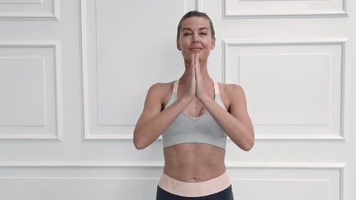 Woman Stretches Arms, Fitness and Yoga at Home