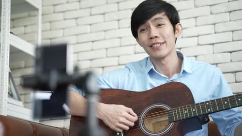 Young Adult Performing Guitar Music for a Stream