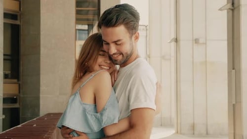 Happy Young Couple Embracing in City
