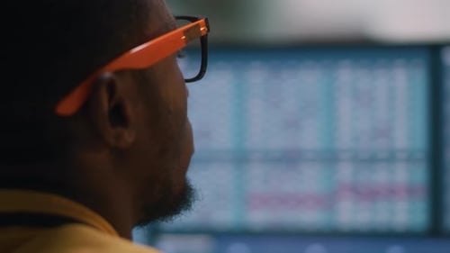 Man analyzing data graphs on computer screen