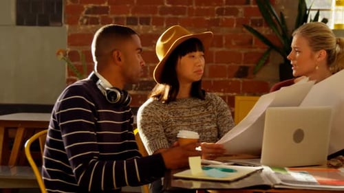 Three Adults Analyzing Blueprints in Office Workplace