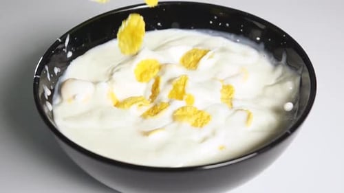 Corn Flakes Falling into Milk Bowl