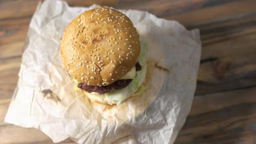 Burger with Lettuce and Tomato on Paper