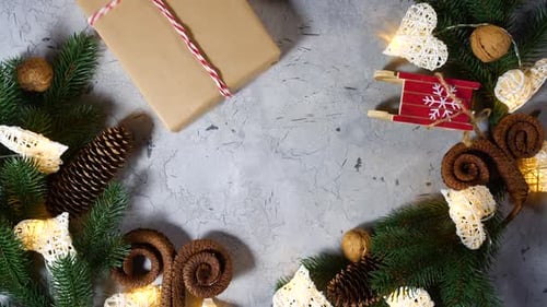 Beautiful Female Hands Add a Christmas Present To the Rest of the Scenery. Cones in the Form of Lamb