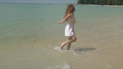 Active Woman Running on Tiptoe Barefoot on Beach