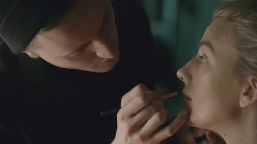 Makeup Artist Applying Lipstick