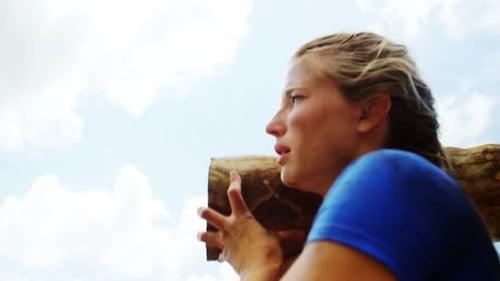 Fit people carrying a heavy wooden log 4k
