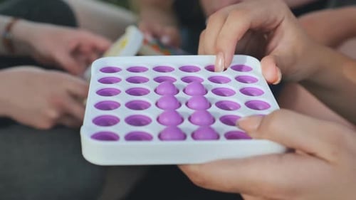 Young Adults Playing With Fidget Toys