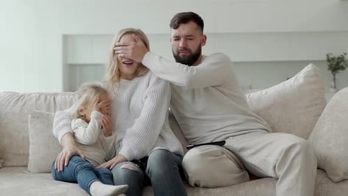 Family Watching a Scary Movie Together at Home