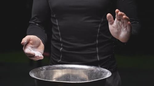 Man Clapping Hands Together with White Powder