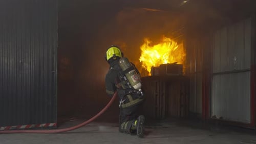Firefighter Kneeling, Fighting Fire in Structure