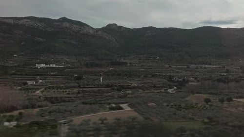 Green Landscape with Mountains and Farmland in Train Window