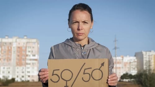 Woman Holds Gender Equality Sign in City