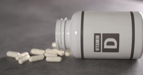 Vitamin D Bottle with White Capsules