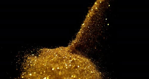 Gold Powder falling against Black Background, Slow motion 4K
