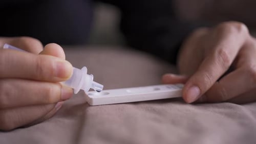 Liquid Being Dispensed on a Medical Test Kit