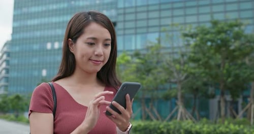 Woman Using Smartphone in Urban Setting